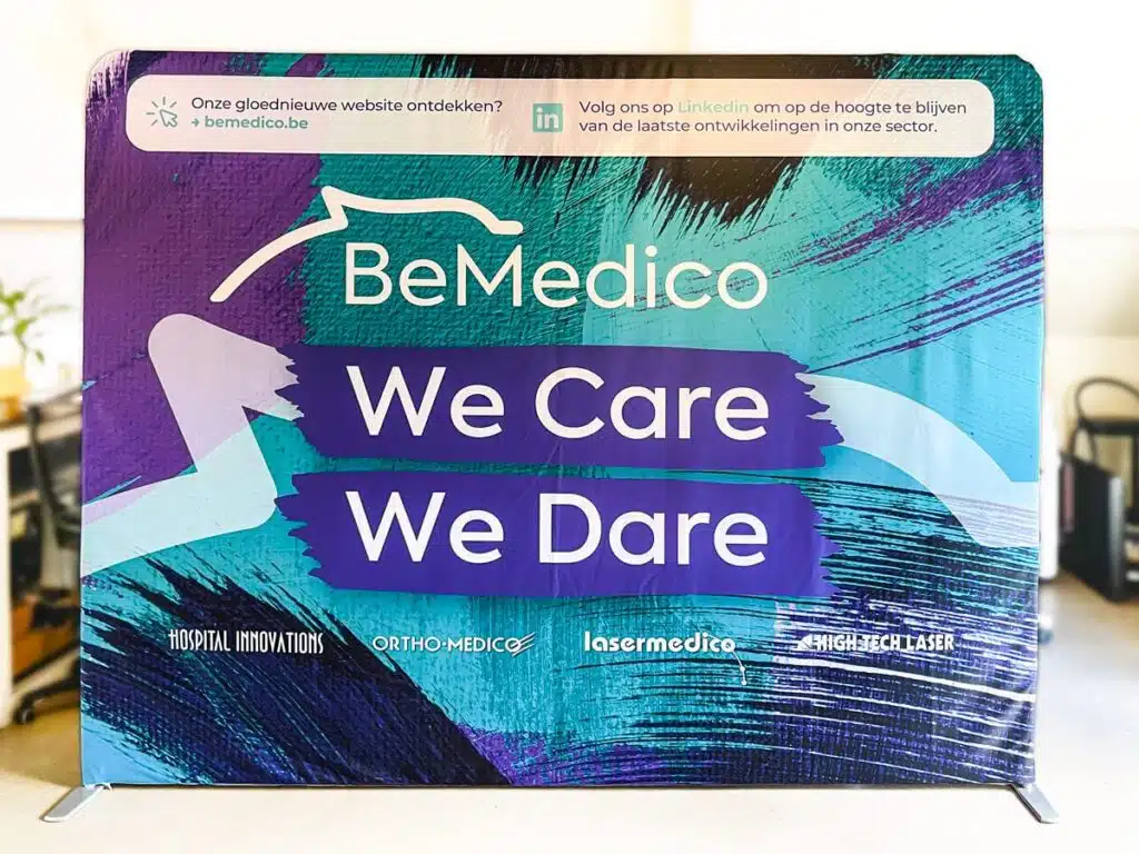 BeMedico Banner: Een promotionele banner van BeMedico met de slogan "We Care, We Dare" en logo's van verschillende divisies zoals Ortho-Medico en Lasermedico.