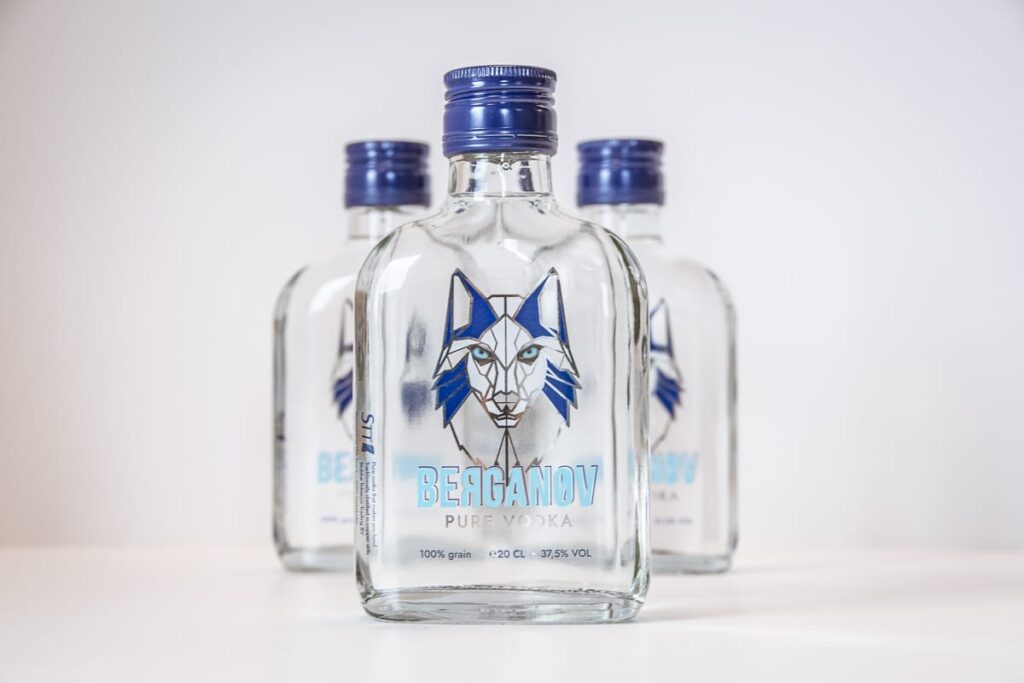 Drie flessen Berganov Pure Vodka naast elkaar, met blauwe schroefdoppen en het lynxlogo op de etiketten