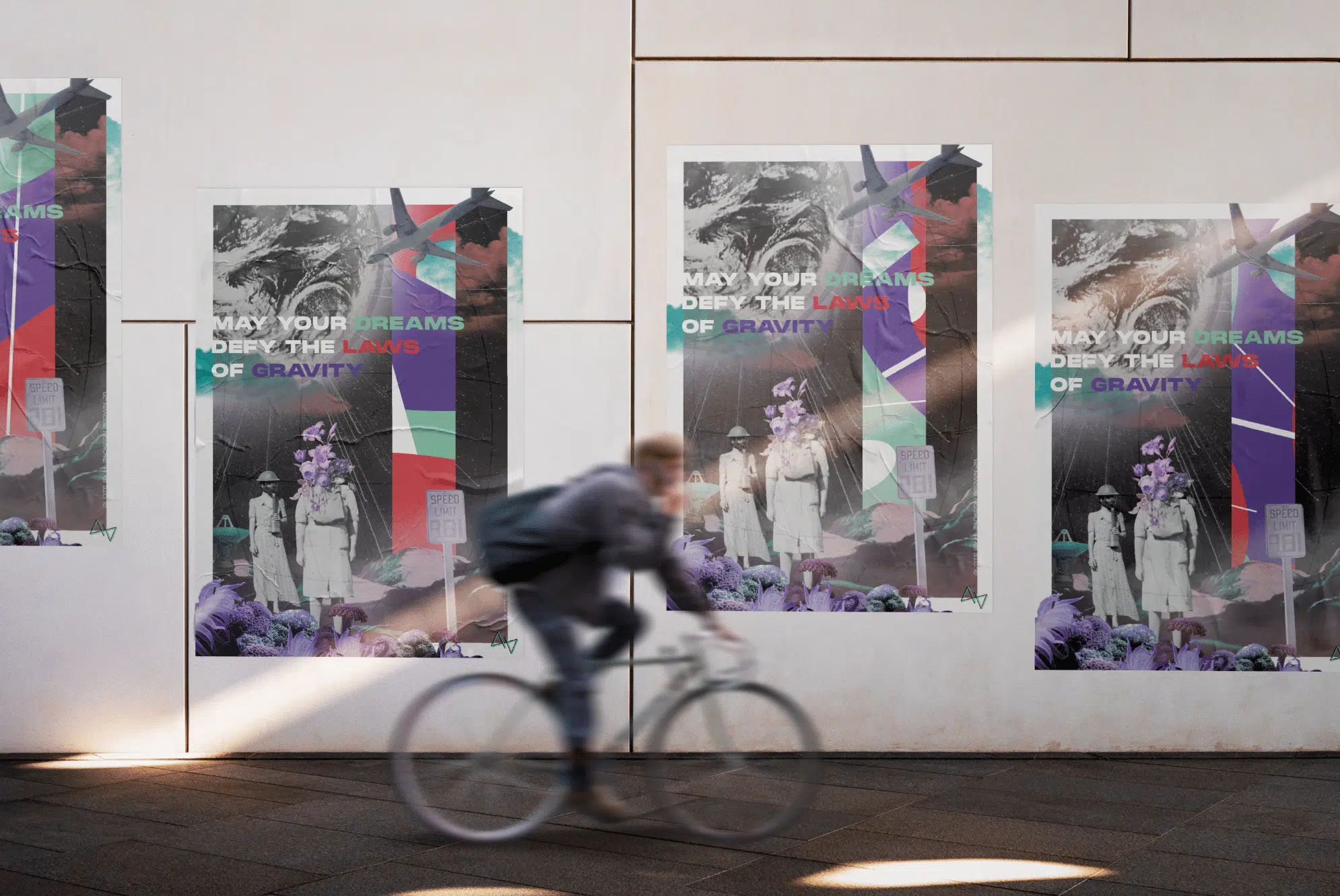 Een muur met posters die deels zijn beschadigd. Op de posters staat de tekst "May your dreams defy the laws of gravity". De afbeelding toont een fietser die langs de muur rijdt, terwijl de posters kleurrijke grafische elementen en vintage foto's bevatten. Posters Variable Data Printing