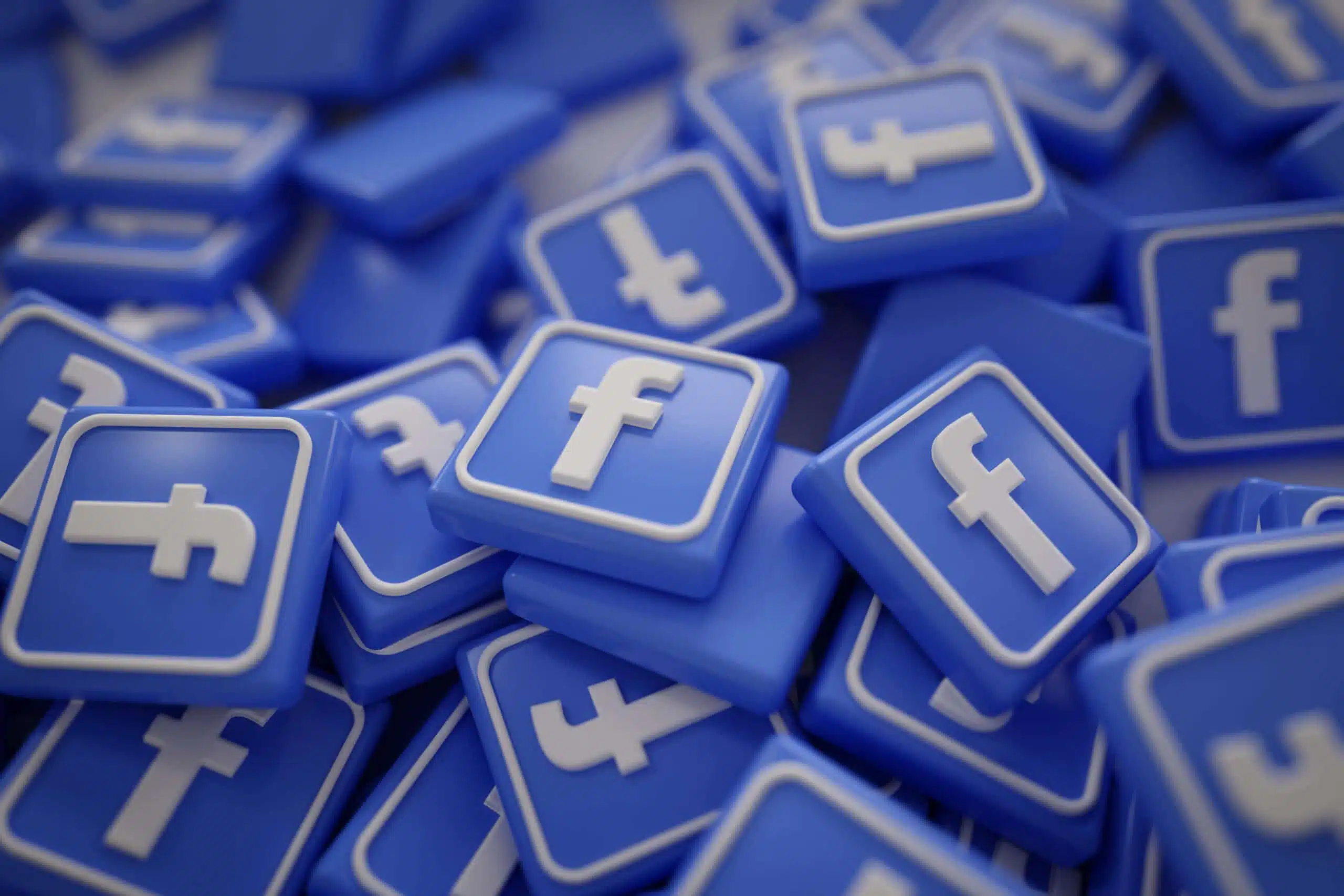 Apple IoS update Een verzamling van 3D facebook logo's die op een stapel liggen